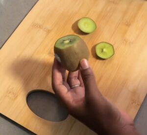 Kiwi on cutting board, ends removed
