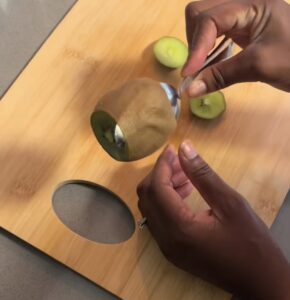 Spoon sliding between kiwi skin and fruit